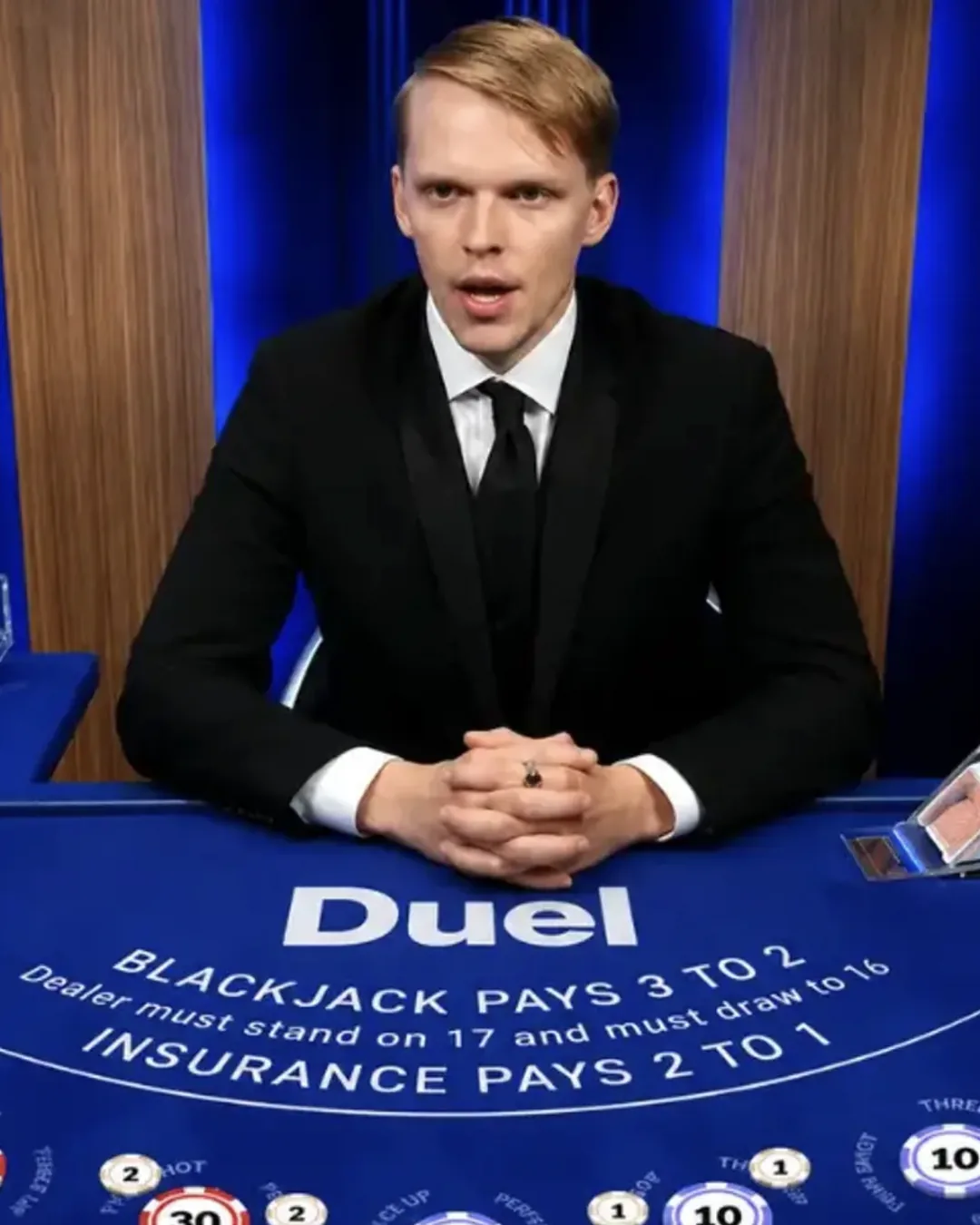 Ossi Ketola dealing at the Duel live blackjack table in a tuxedo