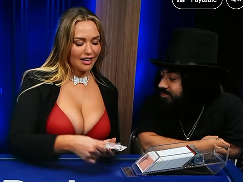 Mia Malkova dealing cards at the Duel live blackjack table